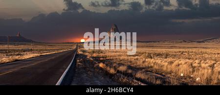 Scenic sunset at a straight road through Navajo Nation in Arizona, USA Stock Photo