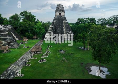 View over the main plaza to the 'Temple of the great jaguar' or 'Temple I' seen from 'Temple II' at the Maya site of Tikal, Peten, Guatemala Stock Photo