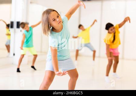 Tween girl krump dancer in choreographic studio with children Stock Photo