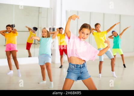 Tween girl krump dancer in choreographic studio with children Stock Photo