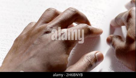 A black man is reading braille Stock Photo