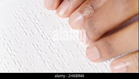 Black fingers are reading braille Stock Photo