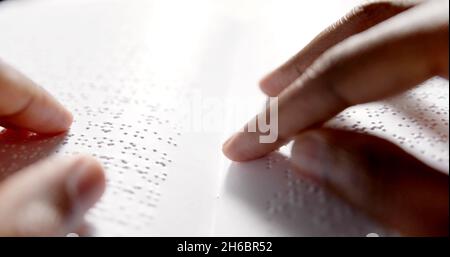 Black hands are reading braille Stock Photo