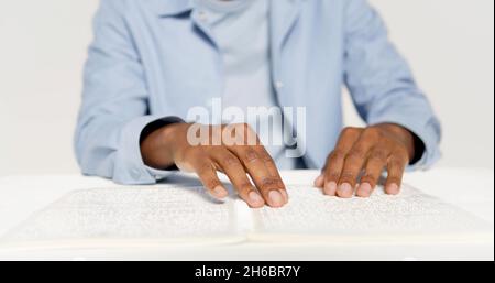 Hands of a man who is reading braille Stock Photo
