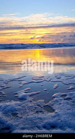 Vertical photo of a beach with foam Stock Photo