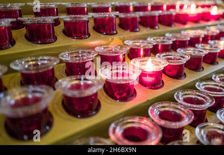 prayer candle votives in a row in church Stock Photo