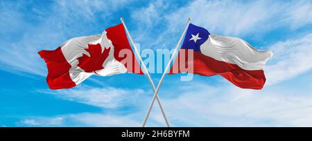 crossed national flags of Chile and canada flag waving in wind at ...