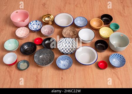 Set of empty bowls of different textures and colors on oak background Stock Photo