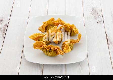 The fried wantan, also called wontun or wonton, is a Chinese dumpling that is served alone or filled with different ingredients can be made both fried Stock Photo