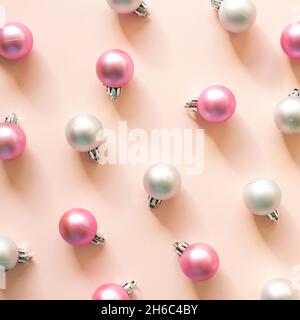 Christmas ornament. Pink and silver baubles on pink background. flat lay, top view Stock Photo