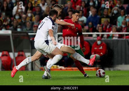 Lisbon, Portugal. 14th Nov, 2021. Portugal's forward Cristiano Ronaldo (R) shoots during the FIFA World Cup Qatar 2022 Qualifying Group A football match between Portugal and Serbia at the Luz stadium in Lisbon, Portugal, on Nov. 14, 2021. Credit: Pedro Fiuza/Xinhua/Alamy Live News Stock Photo
