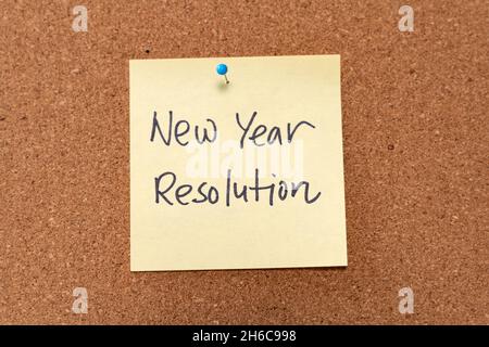New Year resolution written on yellow sticky note pad Stock Photo