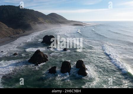 The serene Pacific Ocean washes onto the rugged coastline of Northern California, not far north of Fort Bragg in Mendocino County. Stock Photo