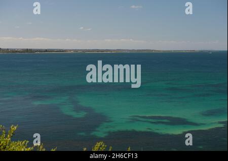 A distant view of the Bellarine Peninsula across the green waters of Port Phillip Bay from Point Nepean in Victoria, Australia. Stock Photo