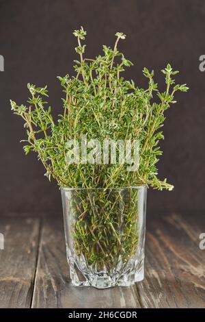 Bouquet of fresh thyme in glass, herbs to add to food Stock Photo