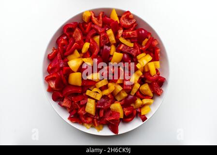 Fresh red and yellow sliced pepper on white background. View from above Stock Photo