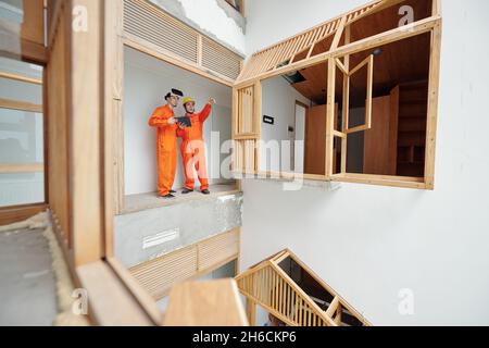 Foreman and workman using virtual reality headset when discussing what part of the house shold be roconstructed Stock Photo