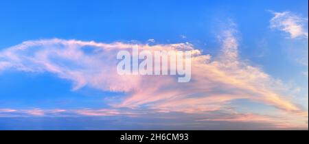 Pink clouds on blue sky background panoramic view, red cirrus cloud texture, beautiful colorful cloudy skies panorama, evening sunset, morning sunrise Stock Photo