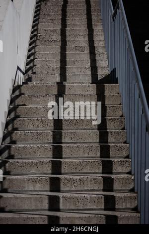 Abstract concrete staircase. Modern design staircase with concrete building. Stock Photo