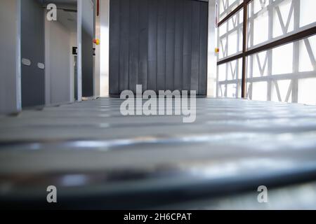 Shallow depth of field (selective focus) image with a x-ray scanning machine at an airport - airport security check. Stock Photo
