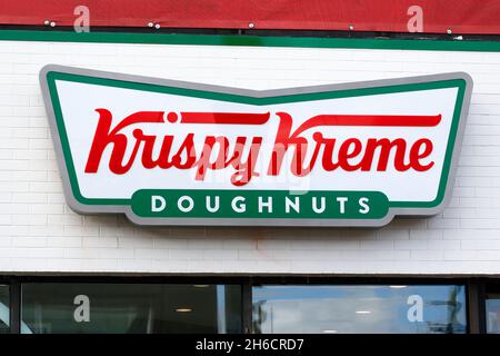 Krispy Kreme doughnuts signage on a wall of a retail store. Stock Photo