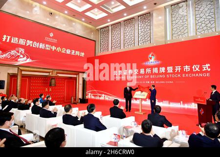 (211115) -- BEIJING, Nov. 15, 2021 (Xinhua) -- Cai Qi (L, on stage), a member of the Political Bureau of the Communist Party of China (CPC) Central Committee and secretary of the Beijing Municipal Committee of the CPC, and Yi Huiman (R, on stage), chairman of the China Securities Regulatory Commission, attend the opening ceremony of the Beijing Stock Exchange, in Beijing, capital of China, on Nov. 15, 2021. The newly-established Beijing Stock Exchange (BSE) started trading Monday, marking a key step in China's efforts to deepen capital market reform and support small businesses. (Xinhua/Li Xin Stock Photo