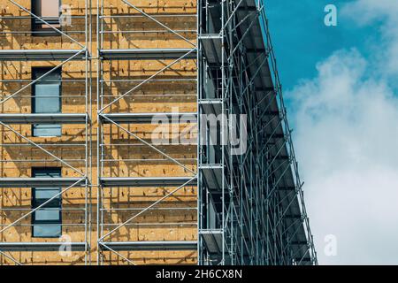 Mineral wool insulation of high-rise apartment building in residential district, construction industry concept Stock Photo