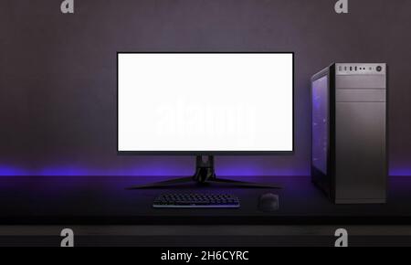 Desk with gaming setup. Display with isolated screen for mockup. Gaming PC,  headset, keyboard, mouse and joypad on desk. Purple led light on wall Stock  Photo