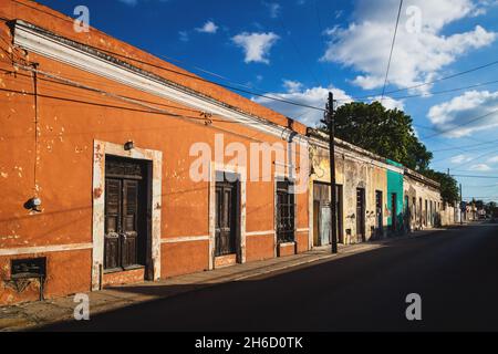 Street with typical Mexican old colorful colonial house facades in Merida, Mexico Stock Photo