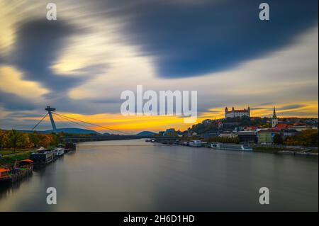 Sunset over Bratislava castle, Danube river and the SNP bridge in Slovakia Stock Photo