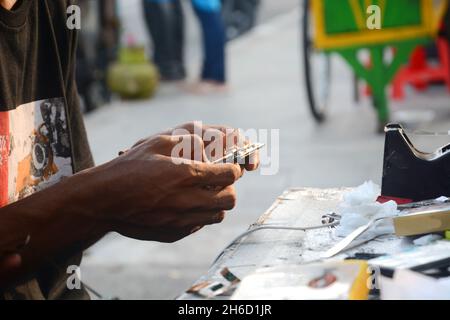 a technician is checking a cellphone Stock Photo