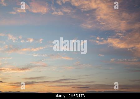 Beautiful dramatic sunset sky with pink clouds lit by the setting sun Stock Photo
