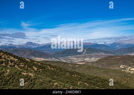 View from viewpoint Santa Cruz de la Seros, Huesca, Spain. The mountains in the background and the blue sky with clouds. Stock Photo