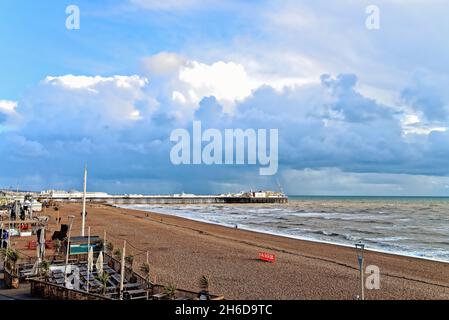 The Palace Pier and seafront with blue storm clouds forming on the horizon on a autumnal day in Brighton East Sussex UK Stock Photo
