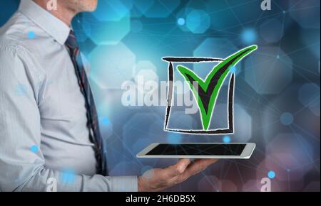 Validation concept above a tablet held by a man Stock Photo
