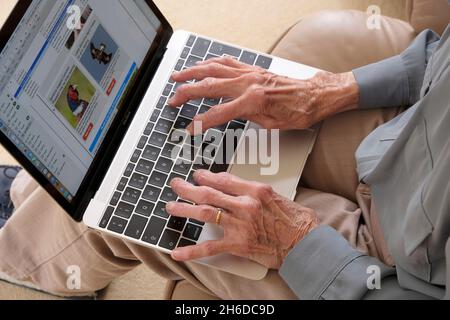 Hands of a senior lady using a laptop computer Stock Photo