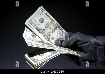 20 dollar bill in a hand in leather glove, USA Stock Photo