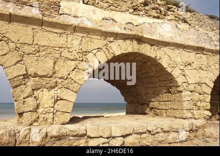 ruins of the Roman aqueduct in Caesarea , Israel, Caesarea Stock Photo