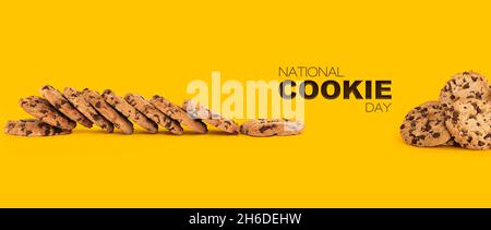 Cookie Day Banner with Lots of Baked Crunchy Homemade Chocolate Cookies on a yellow background Stock Photo