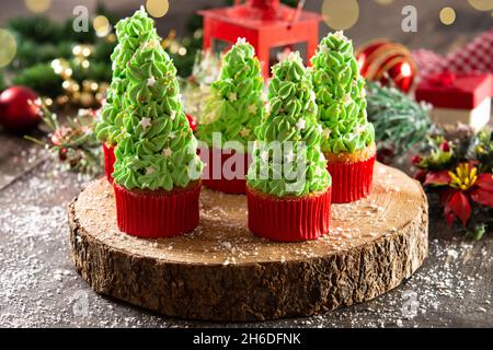 Christmas tree cupcakes on wooden table Stock Photo