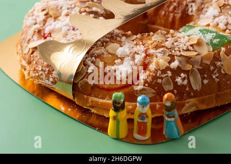 Spanish typical epiphany cake "Roscon de Reyes" on green background Stock Photo