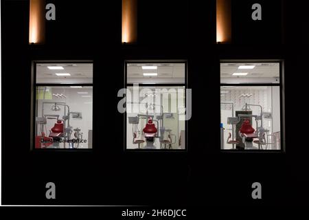 new dental office. night dentistry. red dental chair, view through the window Stock Photo