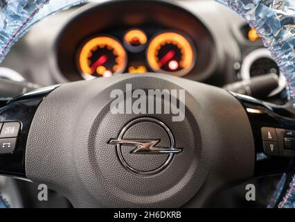 PRODUCTION - 12 November 2021, Hessen, Frankfurt/Main: The steering wheel and dashboard of an Opel Corsa in a workshop at the national competition of the automotive trade. Photo: Frank Rumpenhorst/dpa Stock Photo