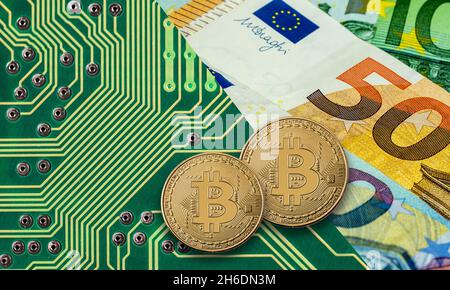 Bitcoin golden coin on green computer circuit board with Euro Stock Photo
