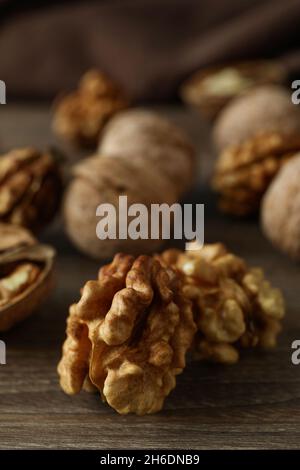 Walnuts with kitchen towel on wooden background Stock Photo