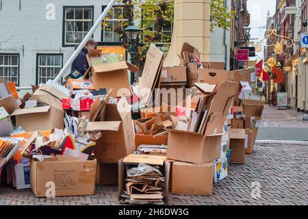 Alkmaar, The Netherlands - November 10, 2021: Stores have collected cardboard waste boxes for weekly pickup in the ancient city center of Alkmaar Stock Photo