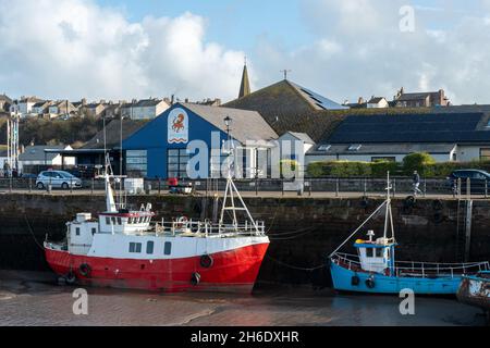 Maryport aquarium and harbour with colourful fishing boats on the coast of Cumbria, England, UK Stock Photo