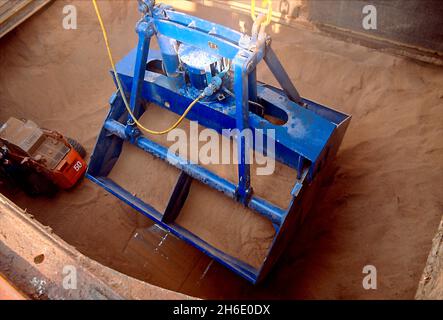 Feed cereals being  unloaded by means of a grabbing crane in the Port of Hamburg. Stock Photo