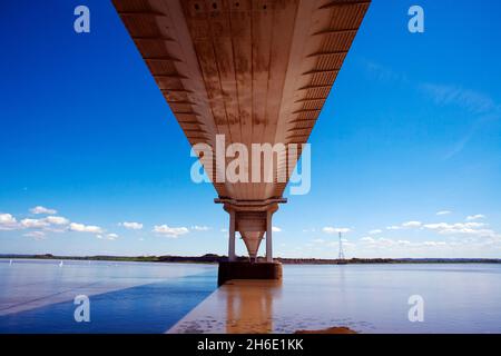 River Severn suspension road bridge between Wales & England underneath the carriageway from the Welsh side near The old Ferry Inn Beachley copy space Stock Photo