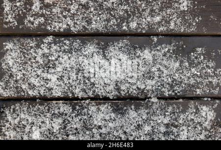 Wooden surface from painted brown boards covered with fresh snow Stock Photo